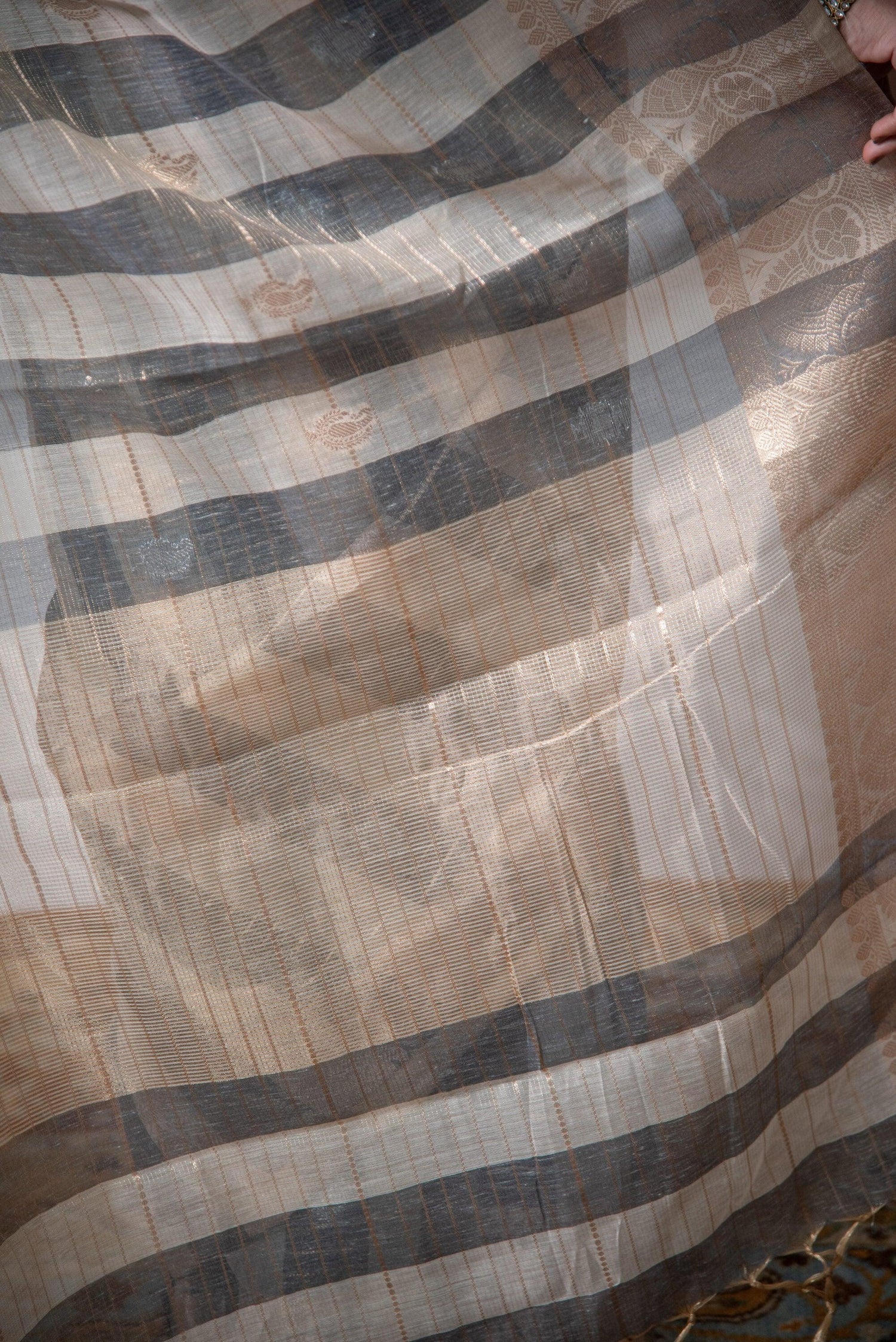 Close-up of lightweight Banarasi cotton linen saree with gold and grey striped pattern