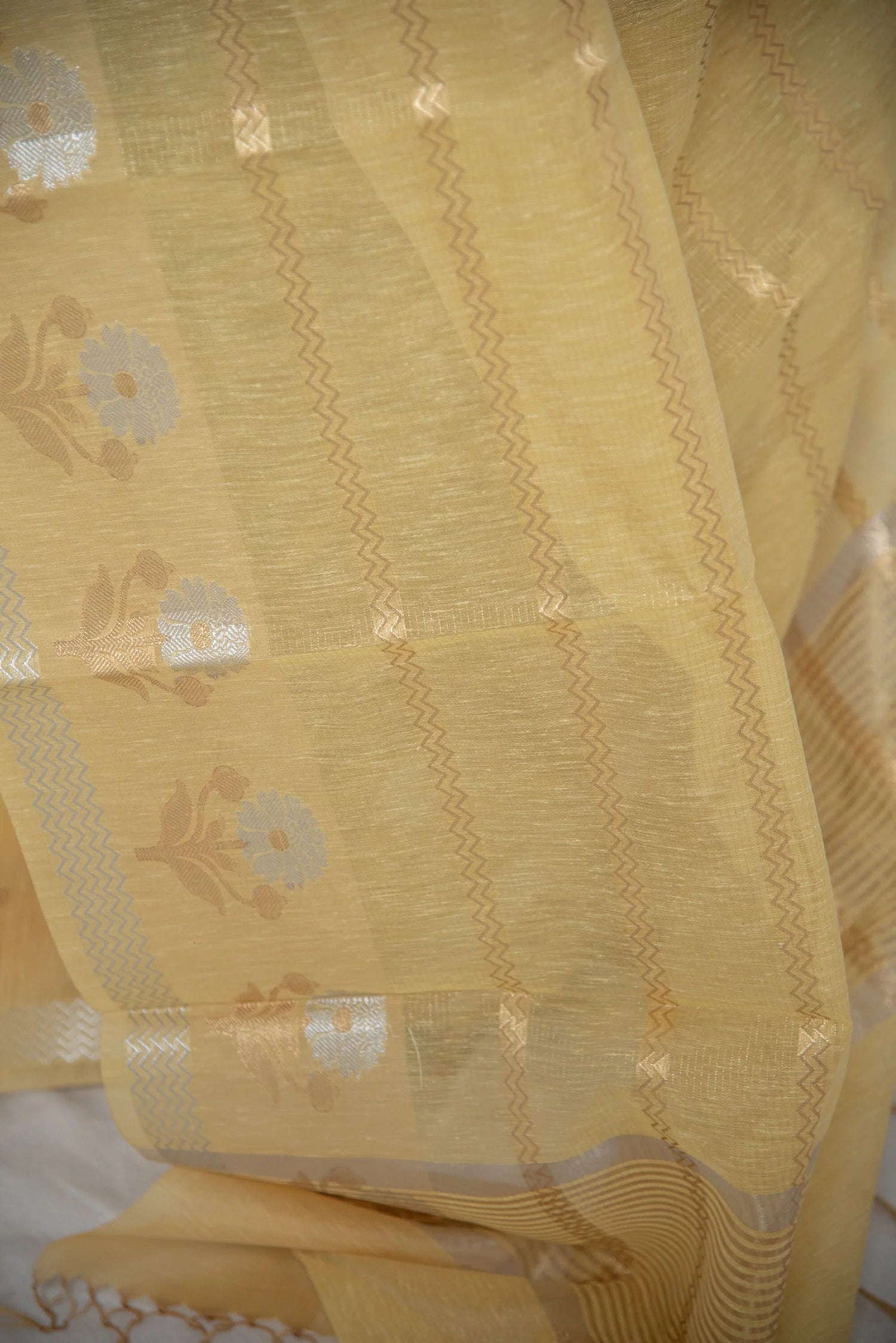 Yellow Banarasi cotton linen silk saree with floral motifs and zari weaving detail