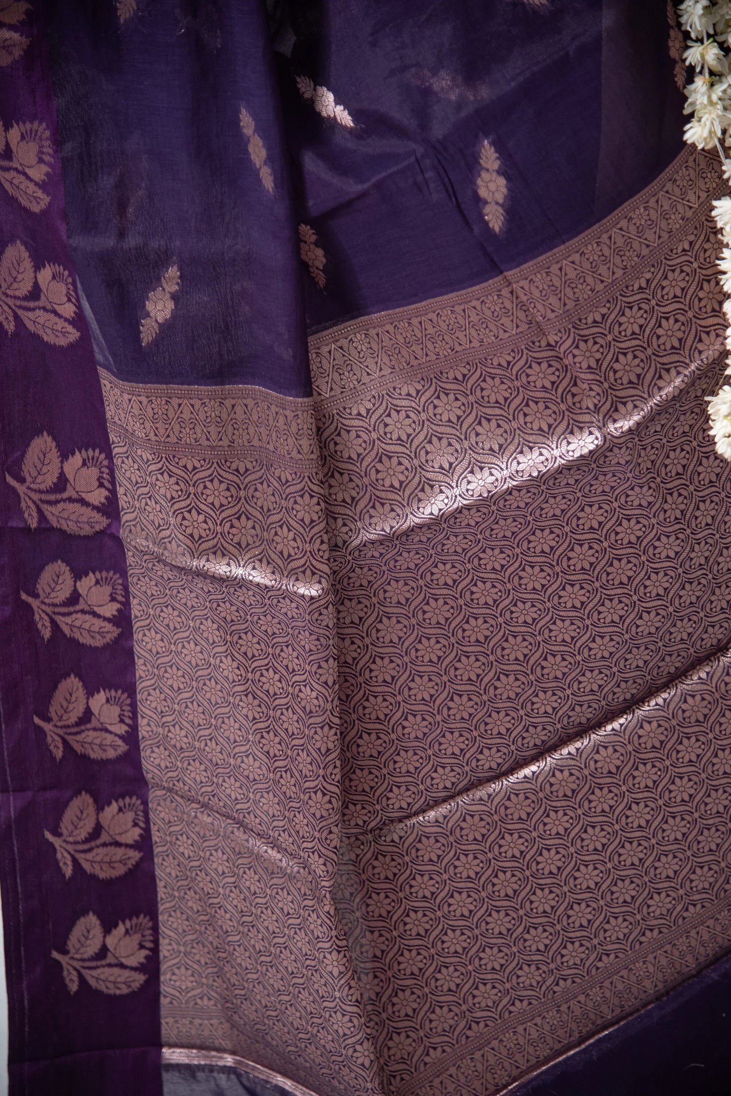 Purple Banarasi cotton saree with intricate gold zari floral motifs and detailed border